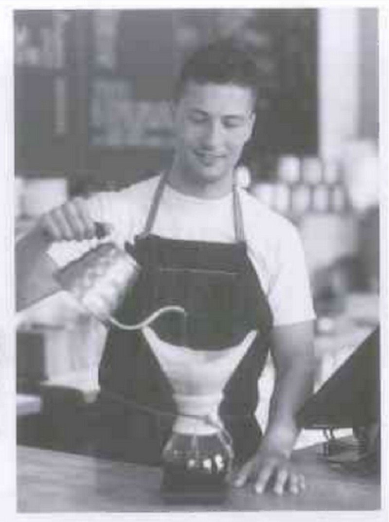 Người phục vụ đang chuẩn bị đồ uống cho khách hàng tại quầy